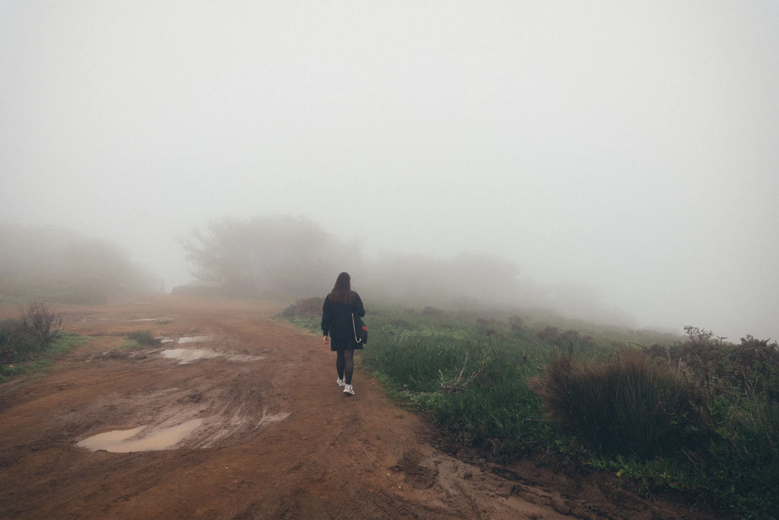 Woman walking alone along a quiet path, taking time out to reset