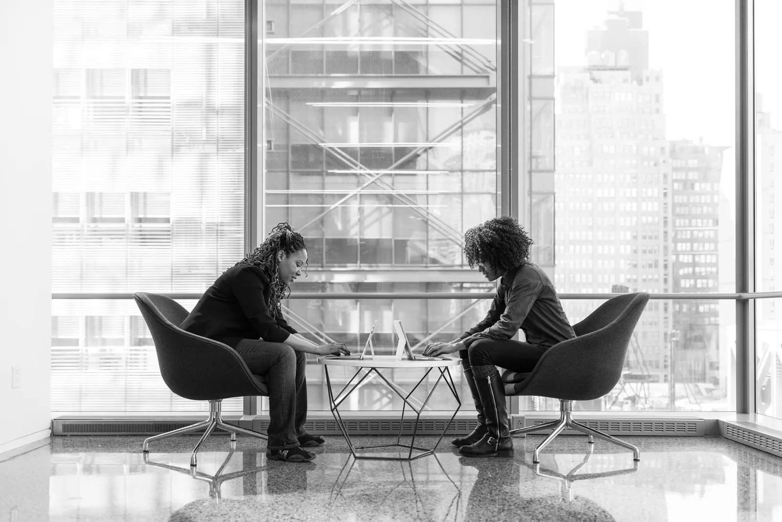 One to one coaching Two women in a one to one coaching discussion at an office table