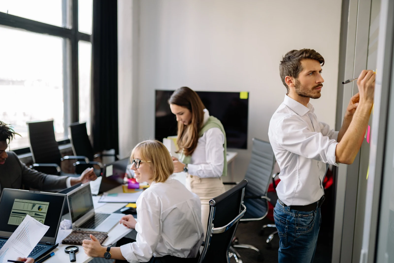 The ripple across a team Diverse group of colleagues collaborating in a modern office